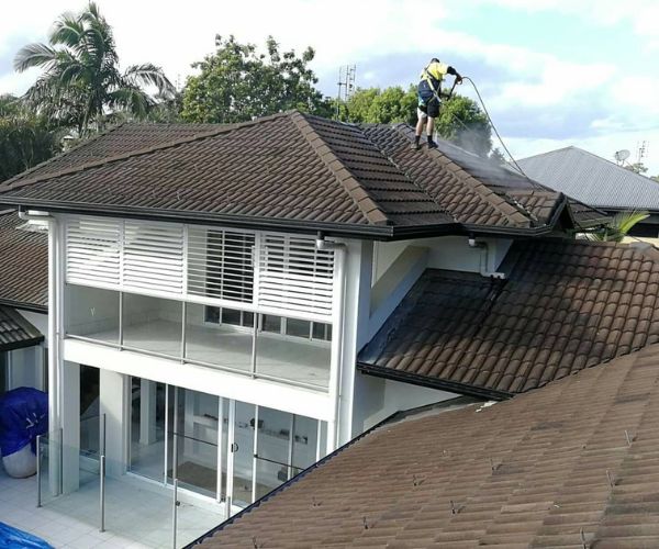 Sunshine Acres pressure cleaning expert washing roof of private property