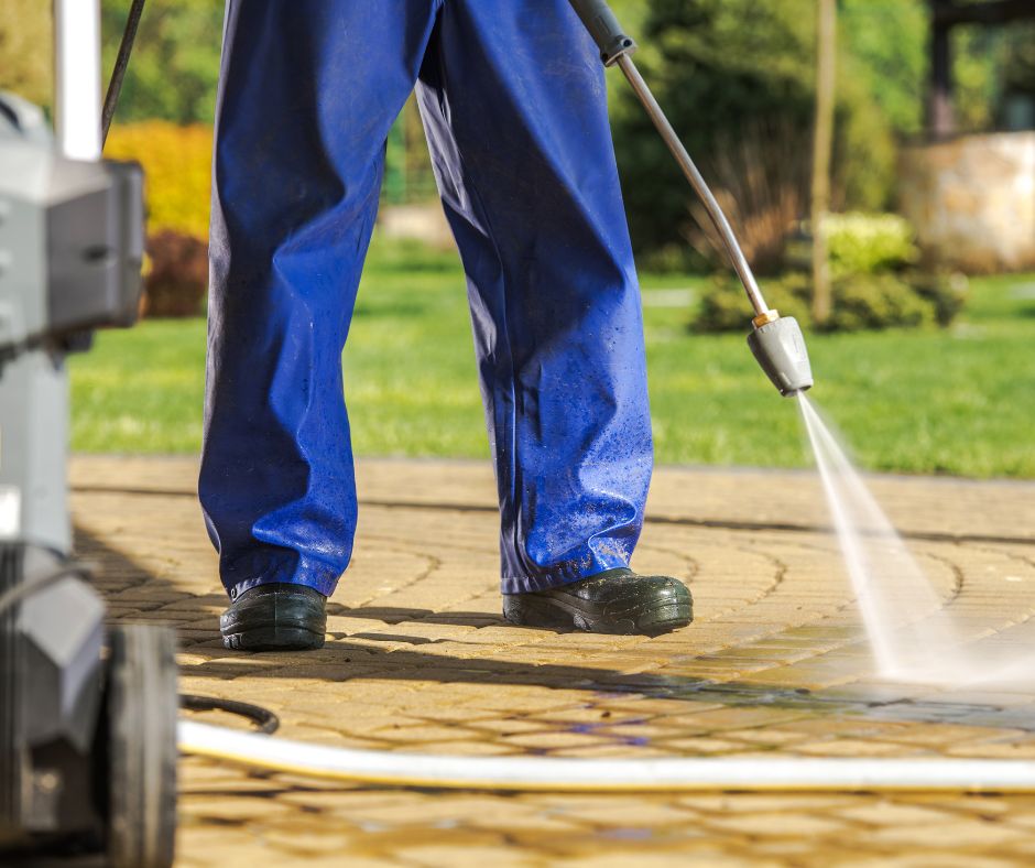 person using pressure washing equipment to pressure clean Sunshine Acres commercial property